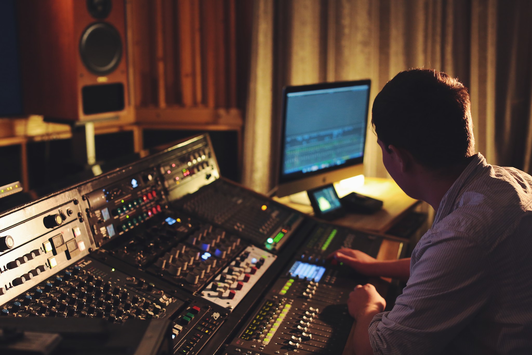 Engineer working at the MixDen Studio console